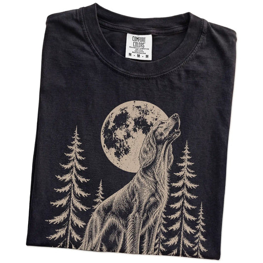 Folded Black Comfort Colors® T-shirt showing a Irish Setter howling beneath the moon and pine trees