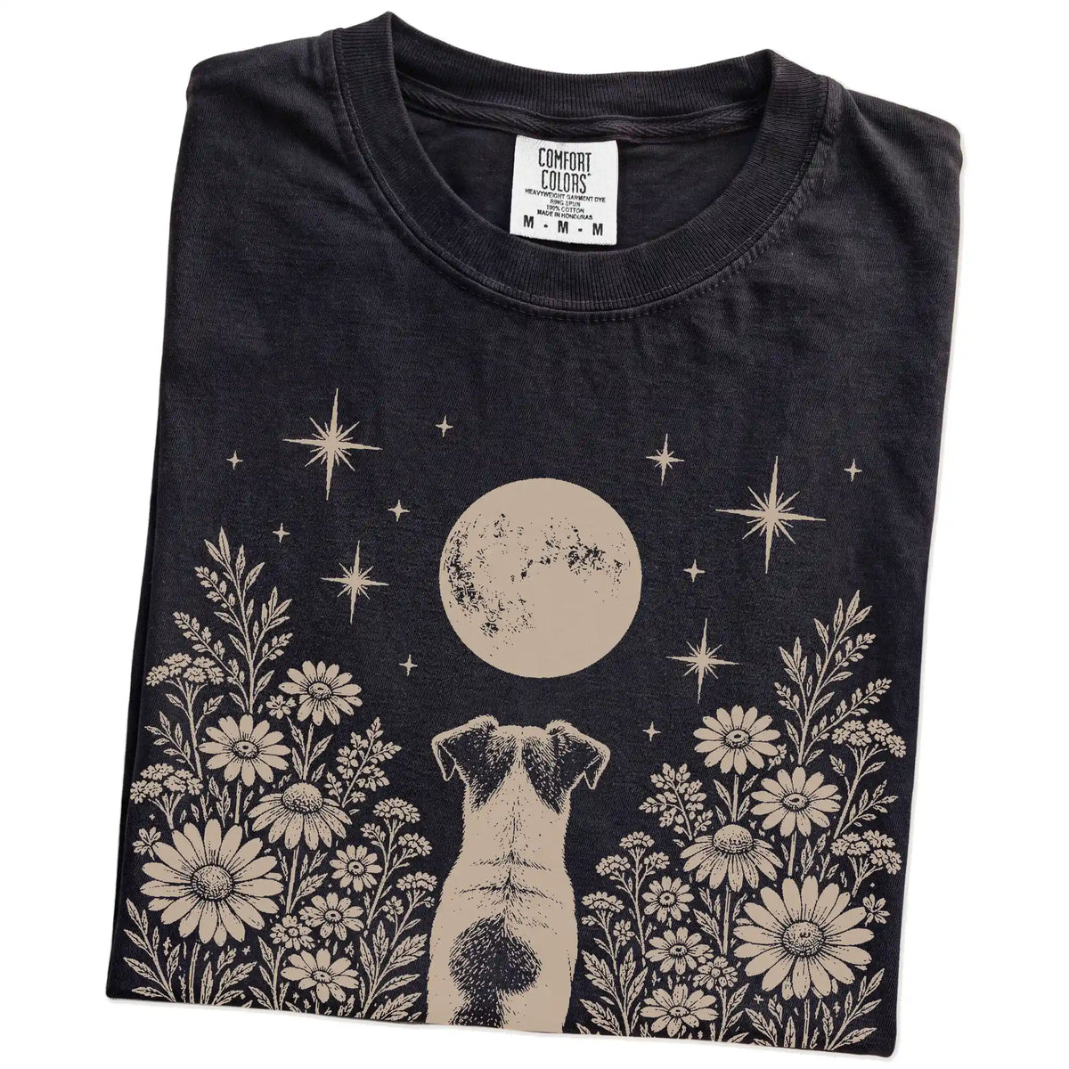 Folded Black Comfort Colors® T-shirt showing Jack Russell beneath a wildflower moon