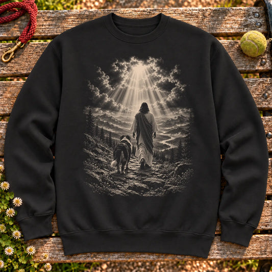 Black crewneck sweatshirt showing Jesus walking beside a Bernese Mountain Dog beneath rays of light