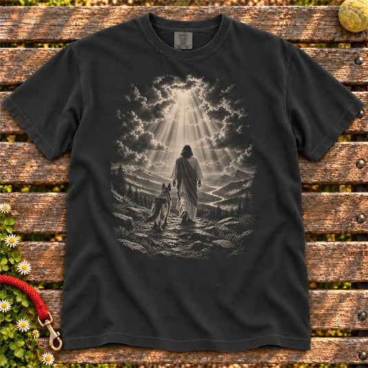 Black T-shirt showing Jesus walking beside a German Shepherd beneath rays of light