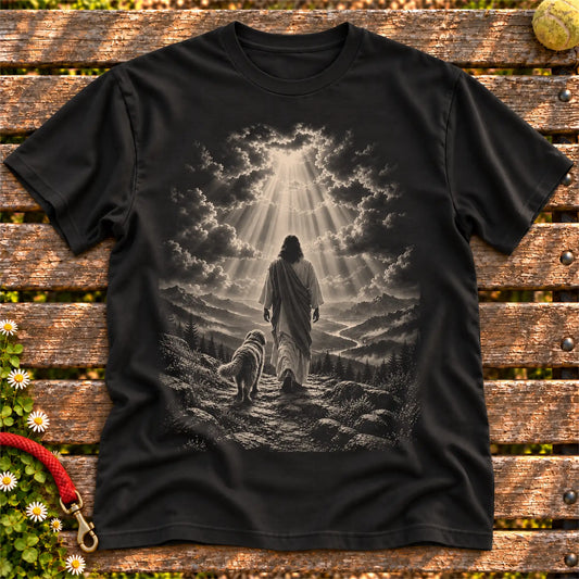 Black T-shirt showing Jesus walking beside a Labradoodle beneath rays of light