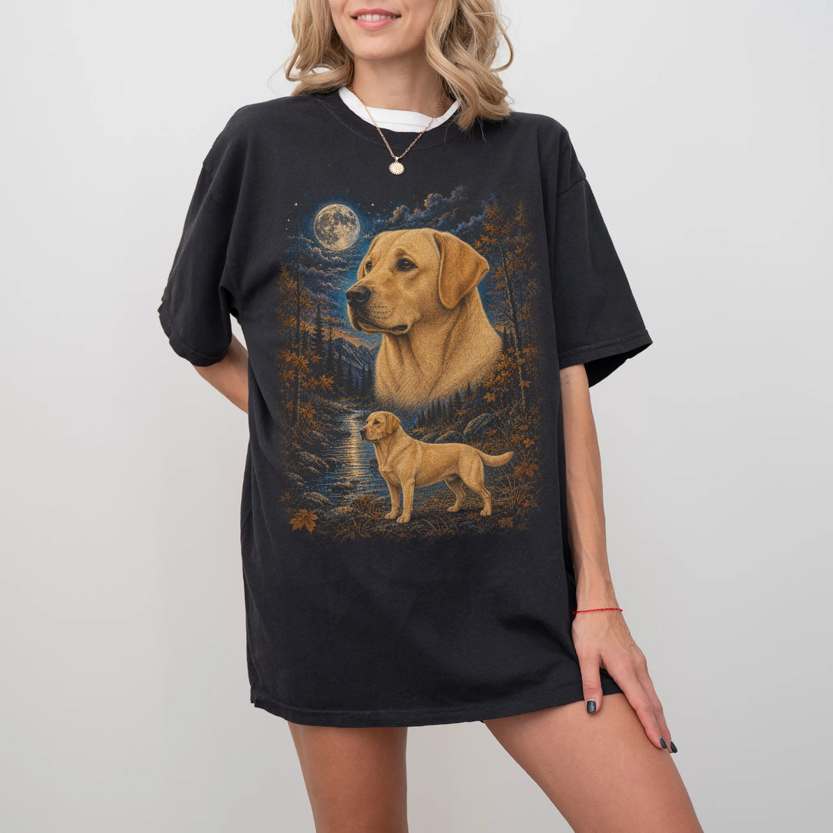 Model wearing a Black Comfort Colors® t-shirt featuring Labrador Retriever in a moonlit fall forest