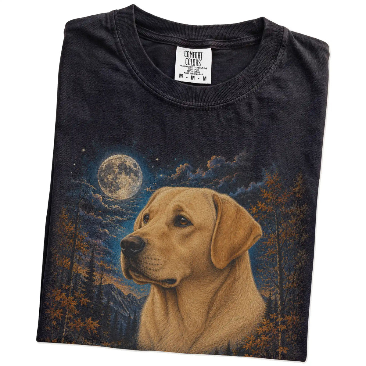 Folded Black Comfort Colors® t-shirt showing Labrador Retriever in a fall forest graphic