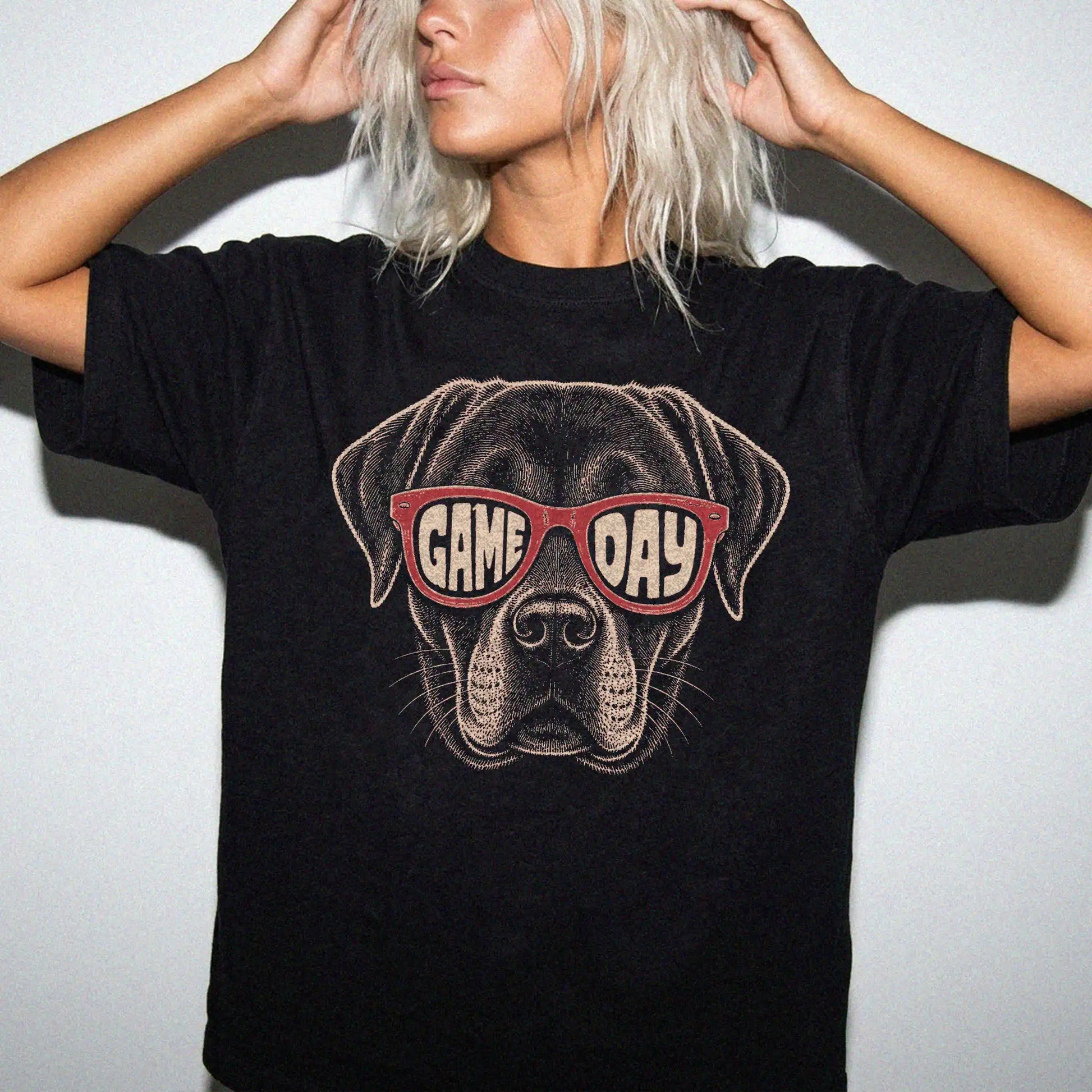 Model wearing a Black Comfort Colors® T-shirt with labrador retriever wearing red game day sunglasses