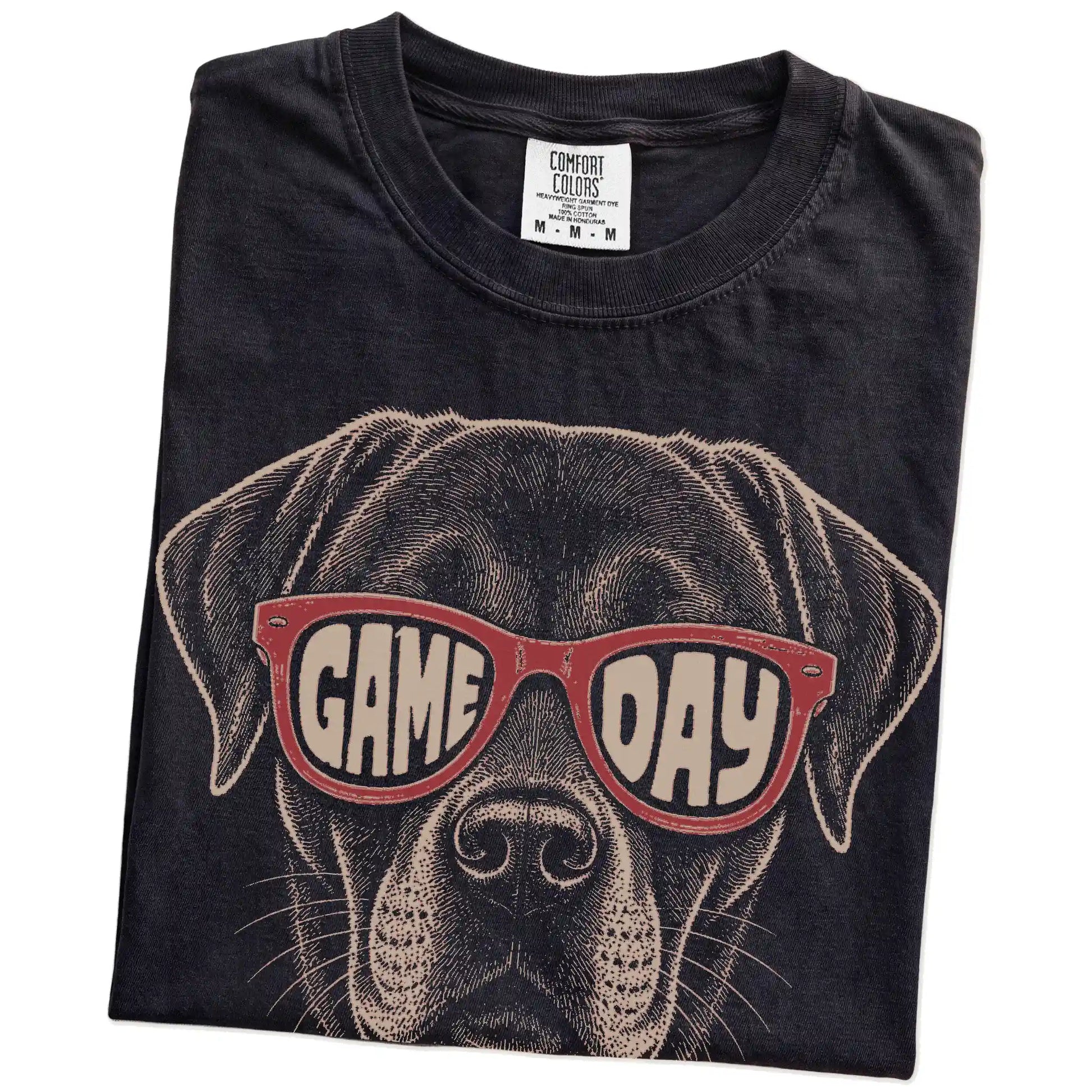 Folded Black Comfort Colors® T-shirt showing labrador retriever wearing red game day sunglasses