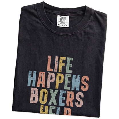 Folded Black Comfort Colors® T-shirt showing Boxer making hard days better with “Life Happens, Dogs Help” lettering