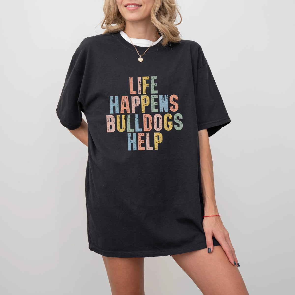 Model wearing a Black Comfort Colors® T-shirt featuring Bulldog making hard days better with “Life Happens, Dogs Help” letter