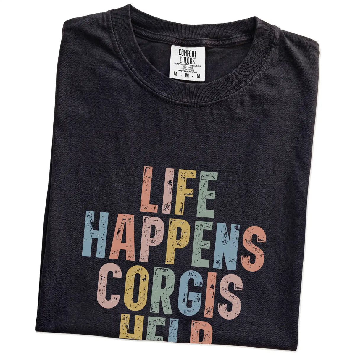 Folded Black Comfort Colors® T-shirt showing Corgi making hard days better with “Life Happens, Dogs Help” lettering