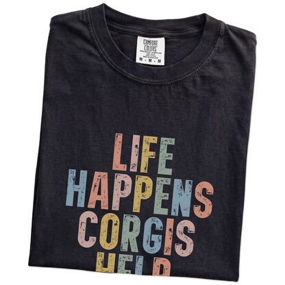 Folded Black Comfort Colors® T-shirt showing Corgi making hard days better with “Life Happens, Dogs Help” lettering