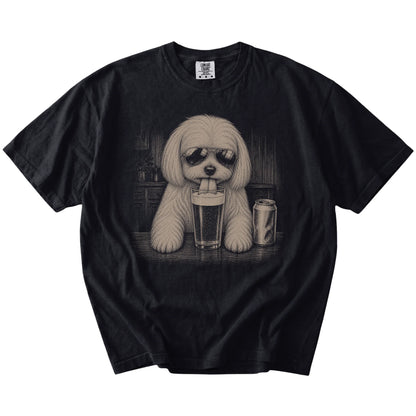 Maltese sneaking a drink from a foamy pint at home on a Black Comfort Colors® t-shirt
