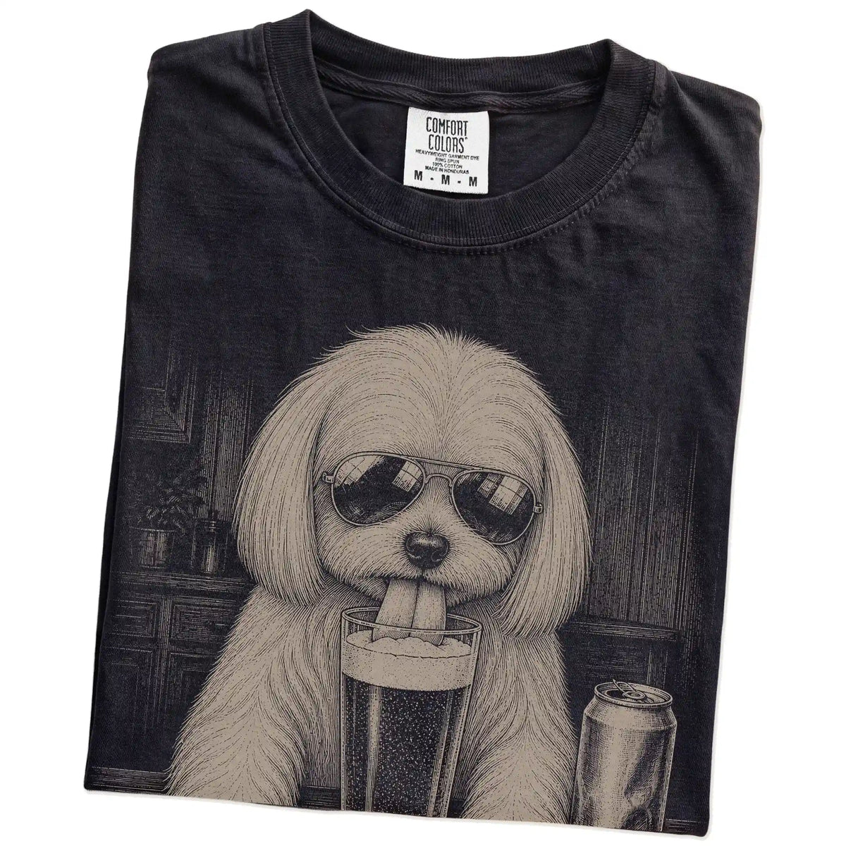 Folded Black Comfort Colors® t-shirt showing Maltese sneaking a drink from a pint
