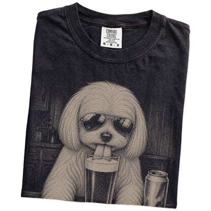 Folded Black Comfort Colors® t-shirt showing Maltese sneaking a drink from a pint