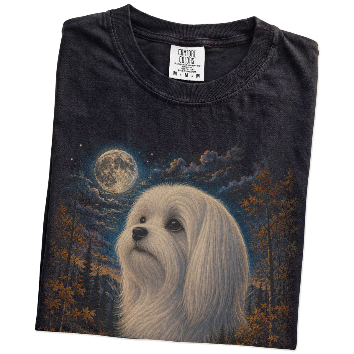 Folded Black Comfort Colors® t-shirt showing Maltese in a fall forest graphic