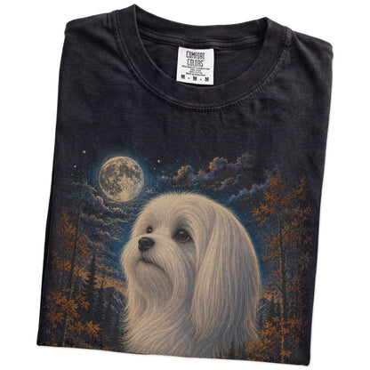 Folded Black Comfort Colors® t-shirt showing Maltese in a fall forest graphic