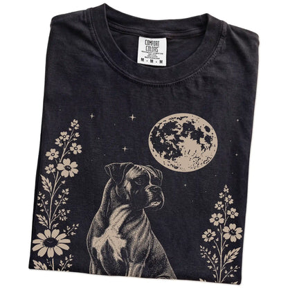 Folded Black Comfort Colors® T-shirt showing Boxer framed by flowers beneath the moon