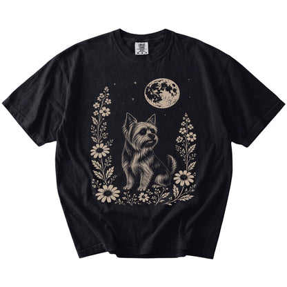Yorkie framed by flowers beneath the moon on a Black Comfort Colors® T-shirt