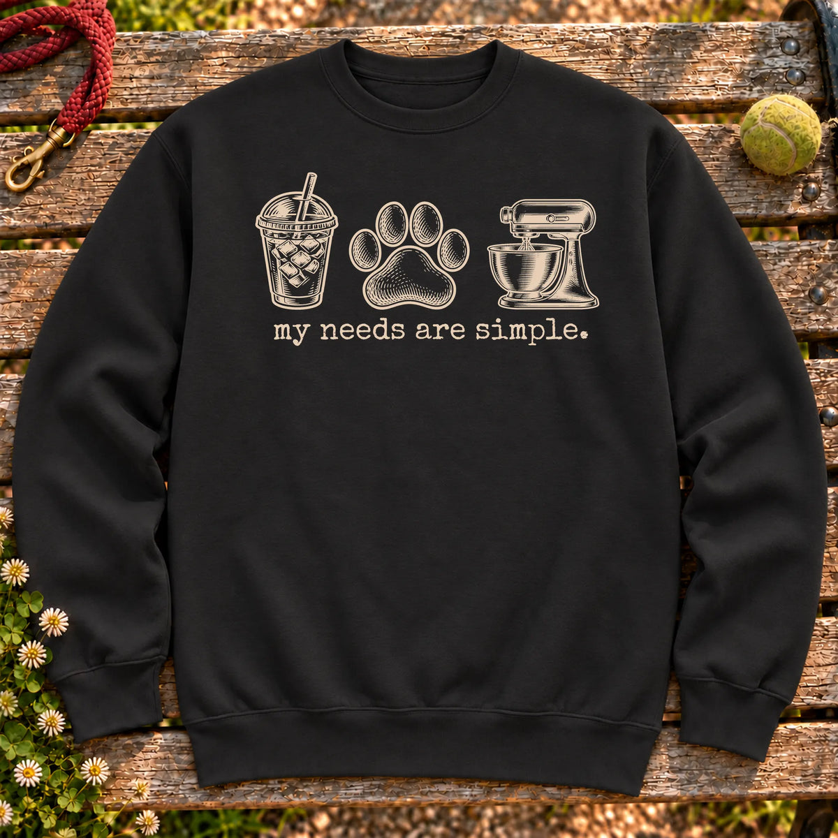 Iced coffee, paw print, and baking design on a Black crewneck sweatshirt