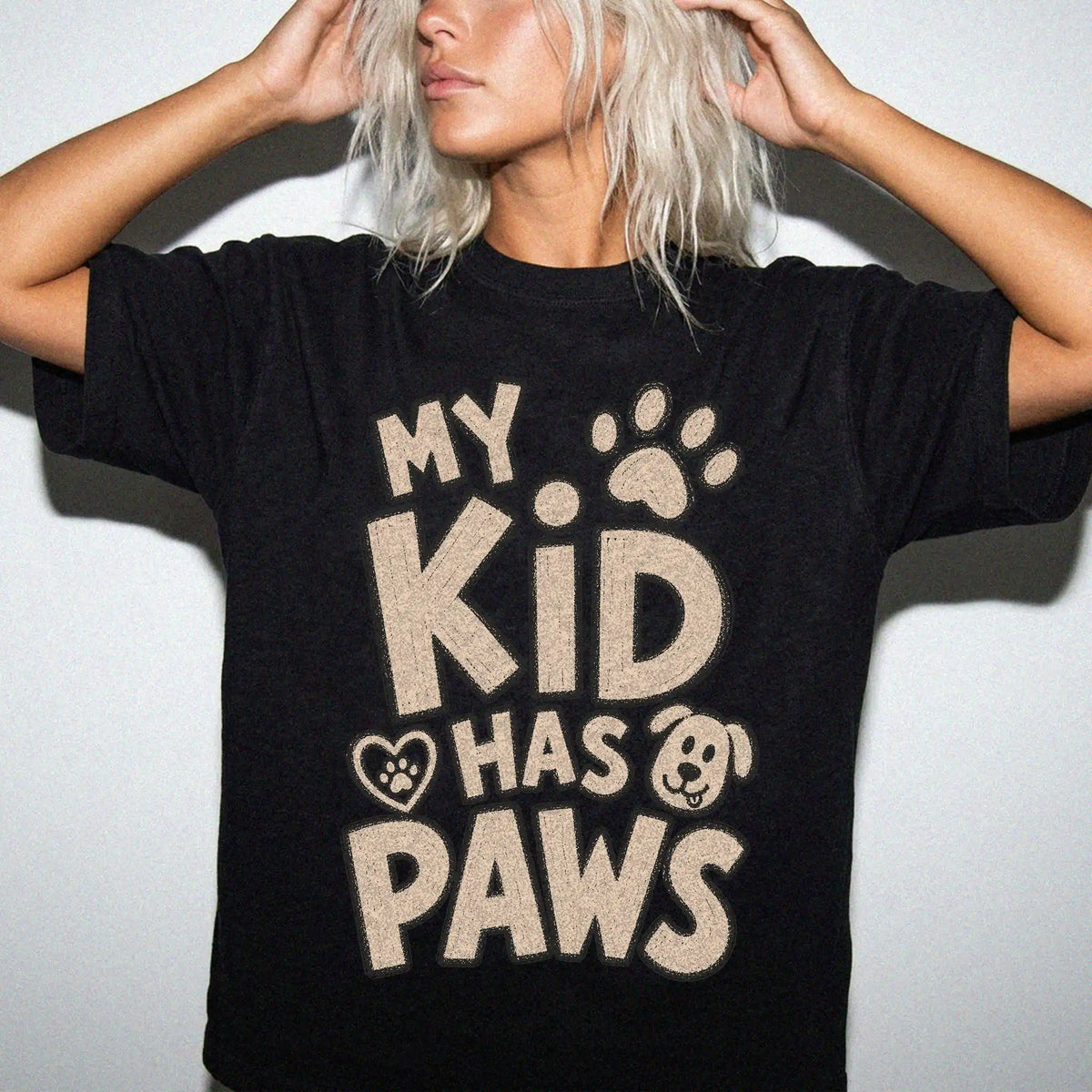 Model wearing a Black Comfort Colors® T-shirt with my kid has paws lettering