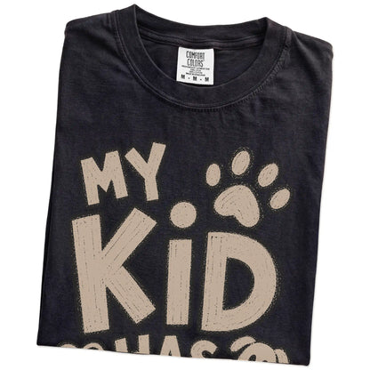 Folded Black Comfort Colors® T-shirt showing my kid has paws lettering
