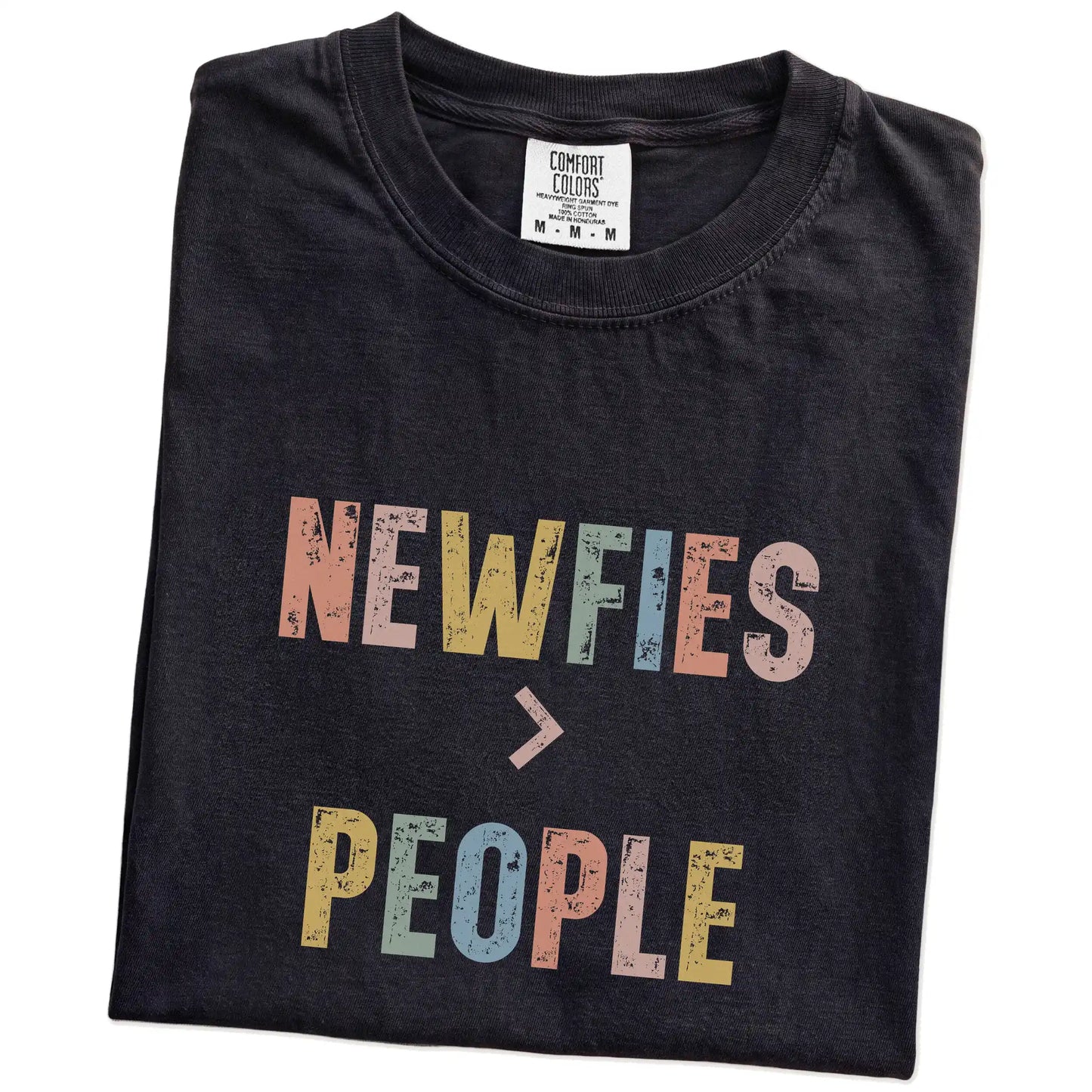 Folded Black Comfort Colors® T-shirt showing “Newfies > People” text