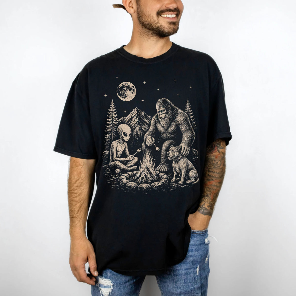 Model wearing a Black Comfort Colors® T-shirt showing Pitbull camping with Bigfoot and an alien