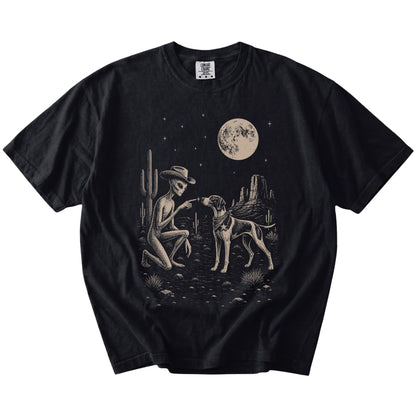 Cowboy alien fist-bumping a Pointer beneath the moon on a Black Comfort Colors® T-shirt