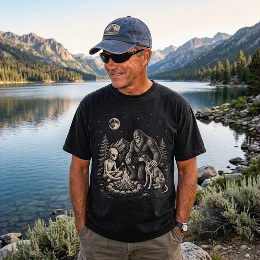Model wearing a Black Comfort Colors® T-shirt showing Pointer camping with Bigfoot and an alien