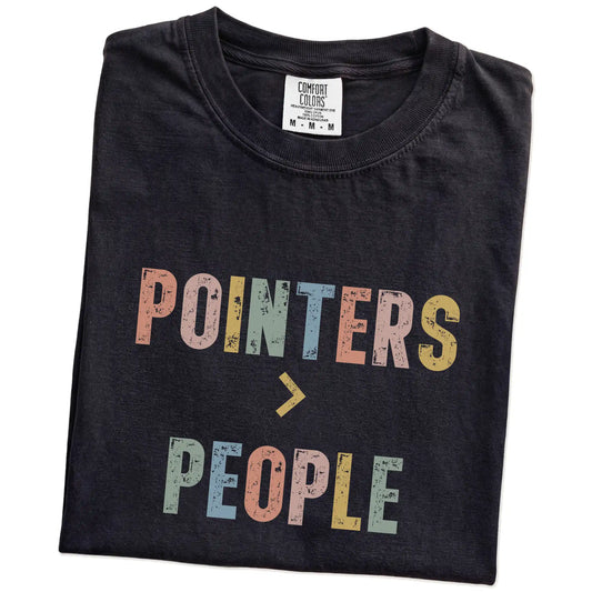 Folded Black Comfort Colors® T-shirt showing “Pointers > People” text