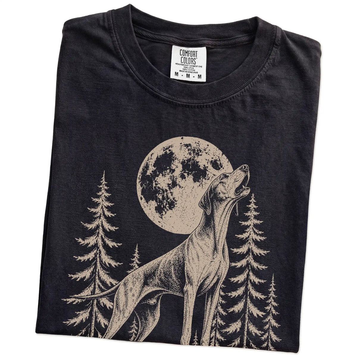 Folded Black Comfort Colors® T-shirt showing a Pointer howling beneath the moon and pine trees
