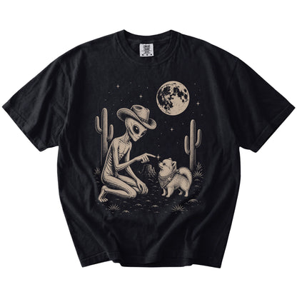 Cowboy alien fist-bumping a Pomeranian beneath the moon on a Black Comfort Colors® T-shirt