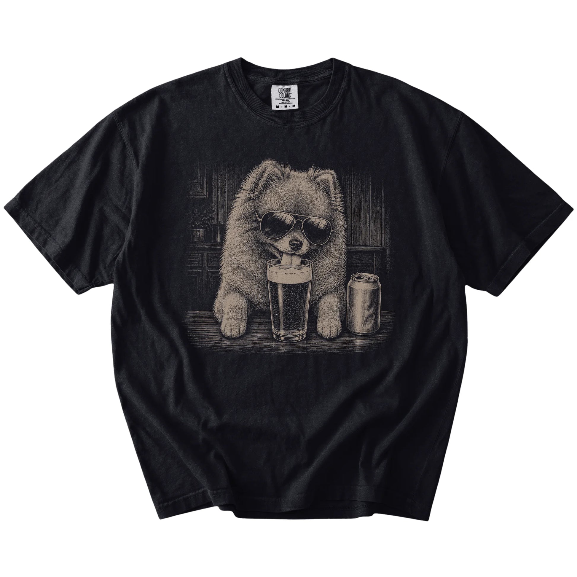 Pomeranian sneaking a drink from a foamy pint at home on a Black Comfort Colors® t-shirt