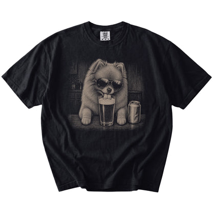 Pomeranian sneaking a drink from a foamy pint at home on a Black Comfort Colors® t-shirt