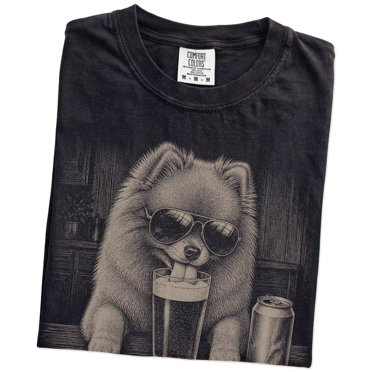 Folded Black Comfort Colors® t-shirt showing Pomeranian sneaking a drink from a pint