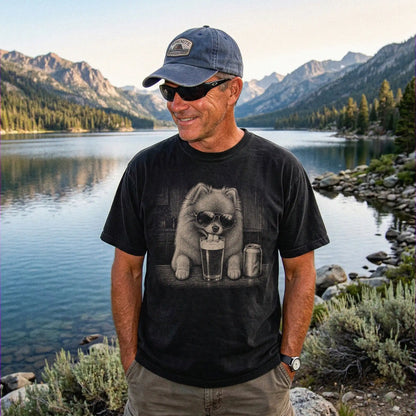 Model wearing a Black Comfort Colors® t-shirt with Pomeranian sneaking a drink from a pint