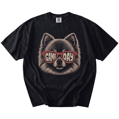Pomeranian wearing red Game Day sunglasses on a Black Comfort Colors® T-shirt