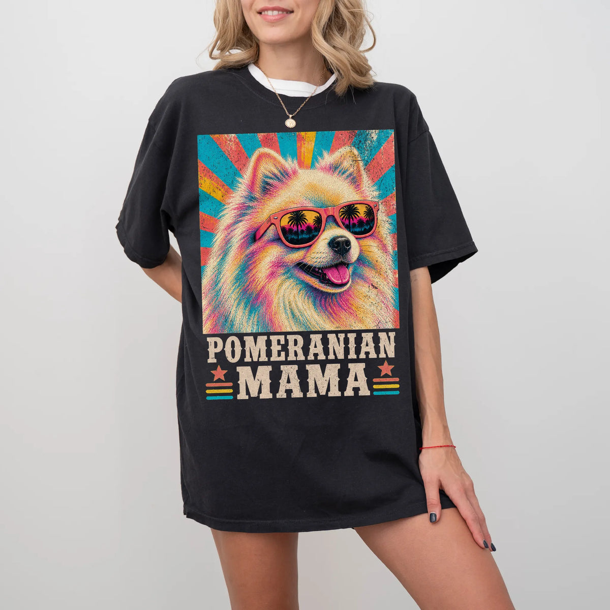 Retro Pomeranian Mama design on a Black Comfort Colors T-shirt worn by a model
