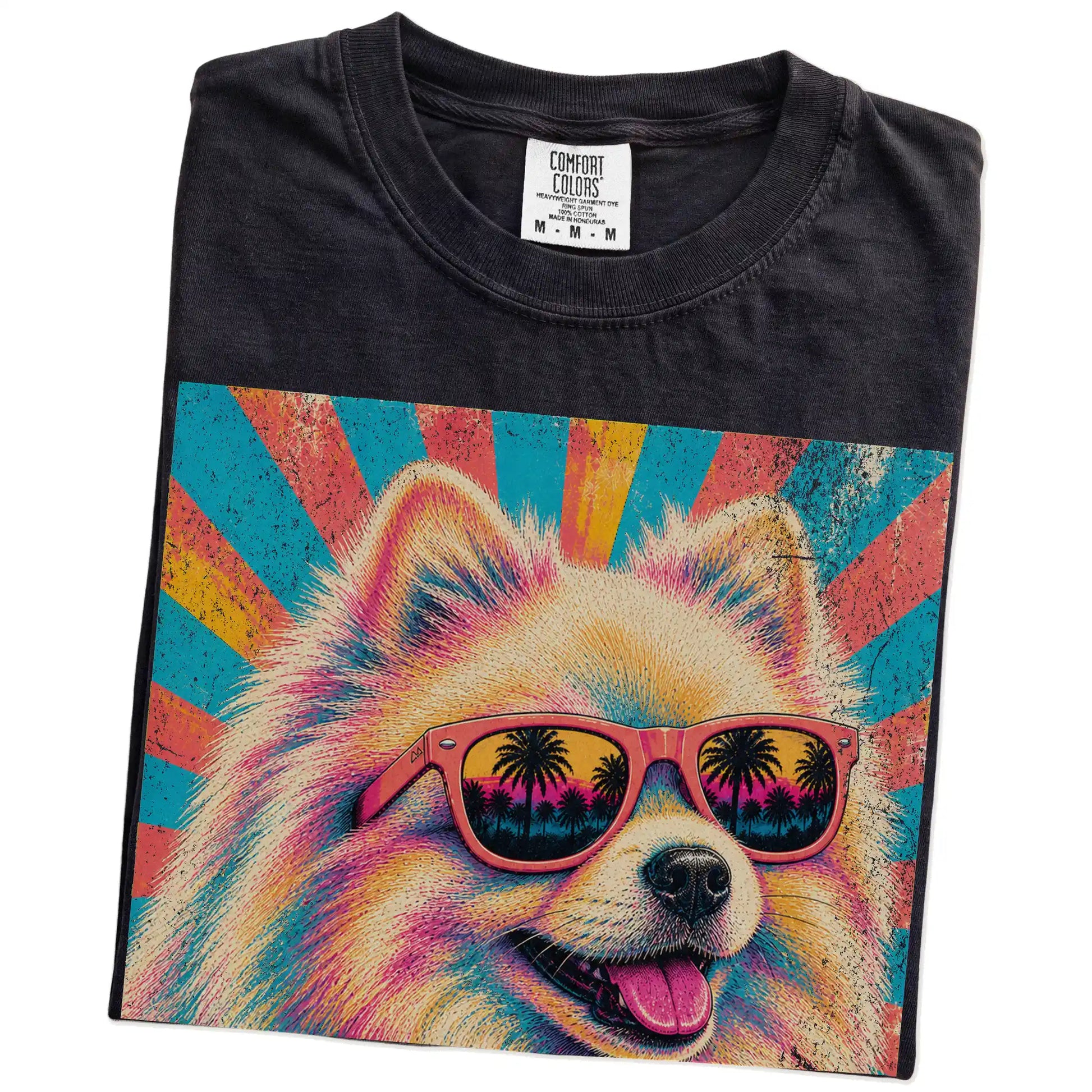 Retro Pomeranian Mama design on a Black Comfort Colors T-shirt folded detail
