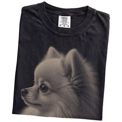 Folded Black Comfort Colors® T-shirt showing a detailed photographic portrait of a Pomeranian