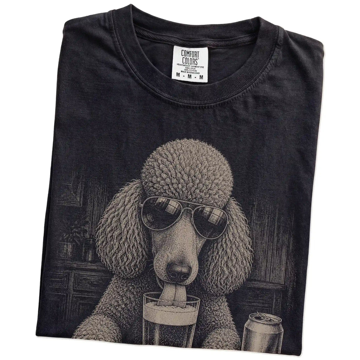 Folded Black Comfort Colors® t-shirt showing Poodle sneaking a drink from a pint