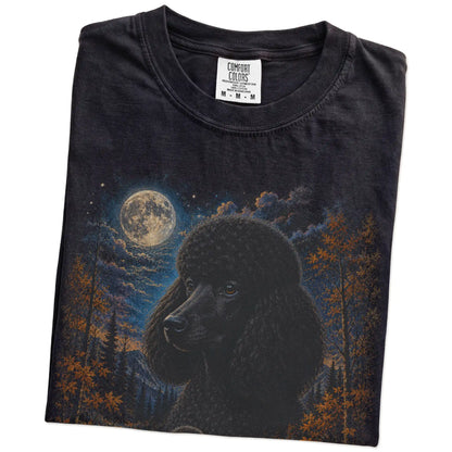Folded Black Comfort Colors® t-shirt showing Poodle in a fall forest graphic