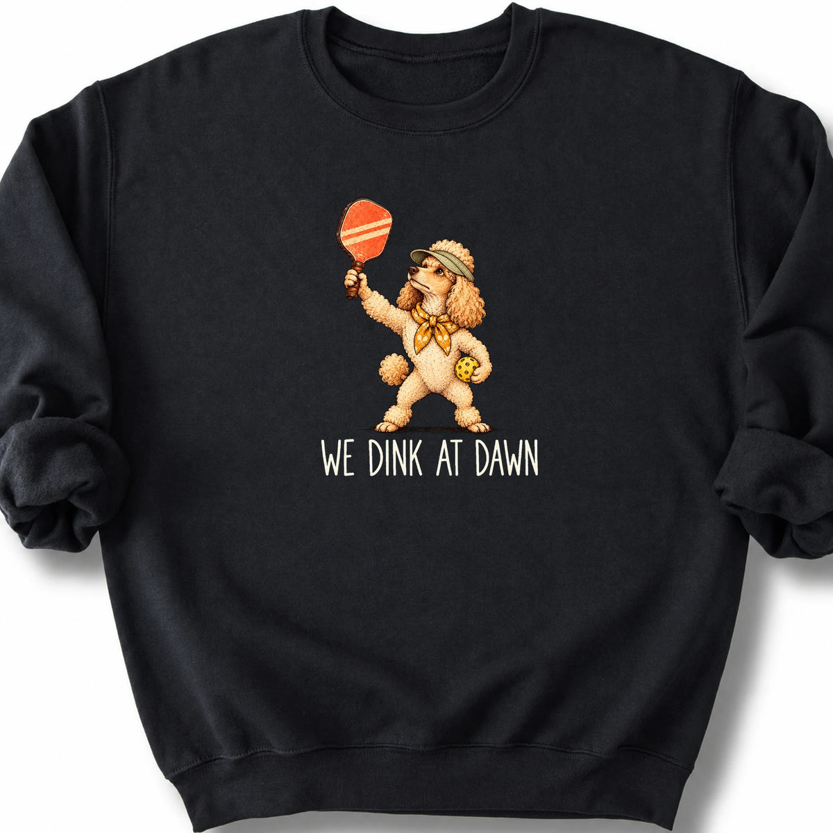 Poodle with a pickleball paddle and ball on a Black Gildan® sweatshirt with We Dink at Dawn text
