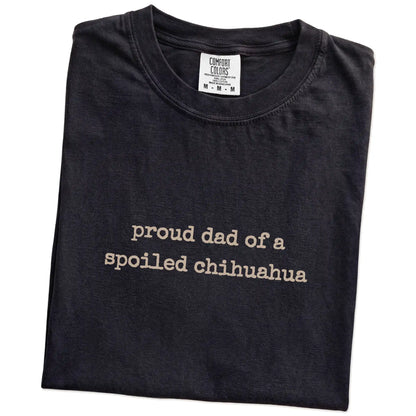 Folded Black Comfort Colors® T-shirt showing proud dad of a spoiled chihuahua lettering