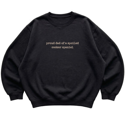 Black Proud Dad of a Spoiled Cocker Spaniel sweatshirt laid flat