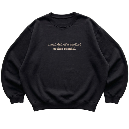 Black Proud Dad of a Spoiled Cocker Spaniel sweatshirt laid flat