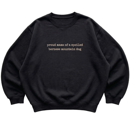 Black Proud Mama of a Spoiled Bernese Mountain Dog sweatshirt laid flat