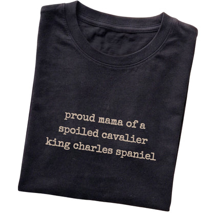 Black Proud Mama of a Spoiled Cavalier King Charles Spaniel T-shirt folded to show the printed design