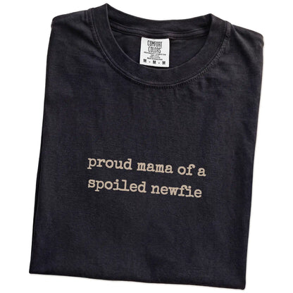 Folded Black Comfort Colors® T-shirt showing Proud Mama of a Spoiled Newfie lettering