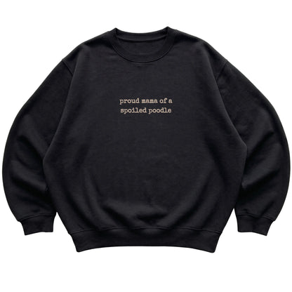 Black Proud Mama of a Spoiled Poodle sweatshirt laid flat