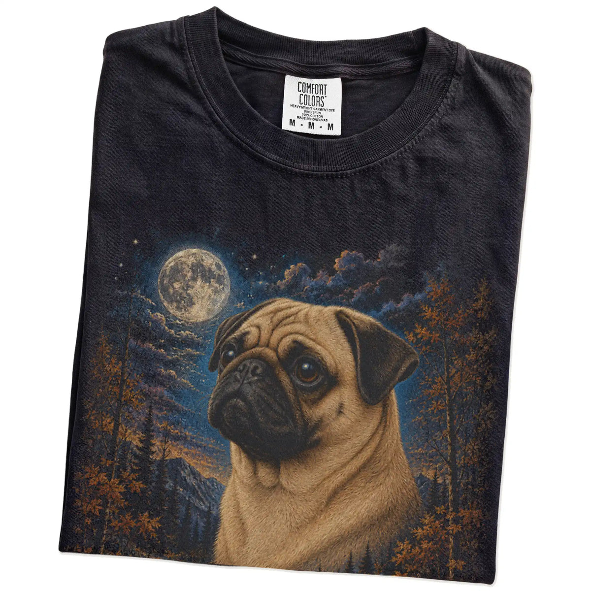 Folded Black Comfort Colors® t-shirt showing Pug in a fall forest graphic