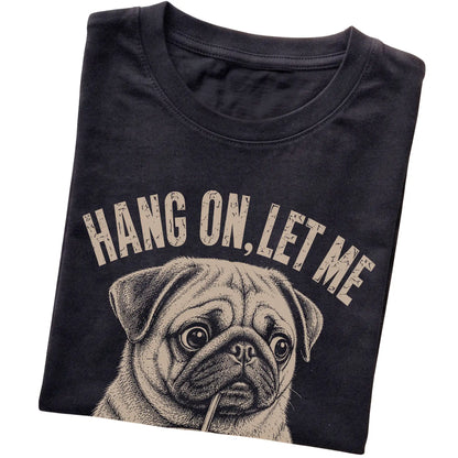 Black T-shirt featuring Overthinking Pug, folded presentation